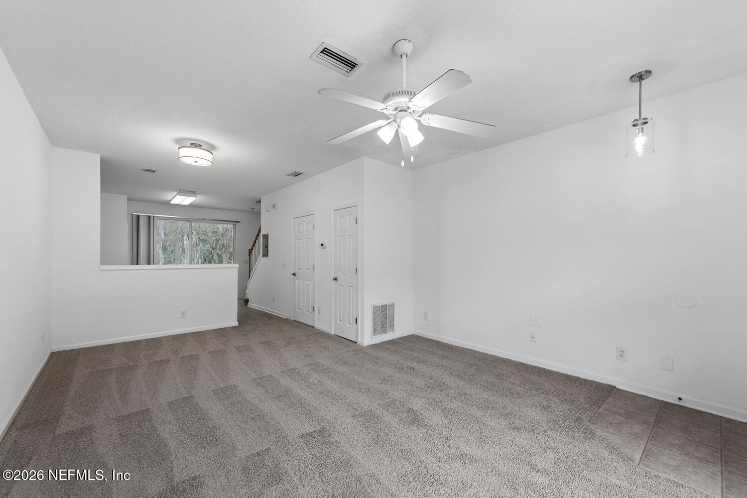 3532 Twisted Tree Lane Jacksonville, FL 32216 - Photo 7 of 23 wooden floor in an empty room with a window
