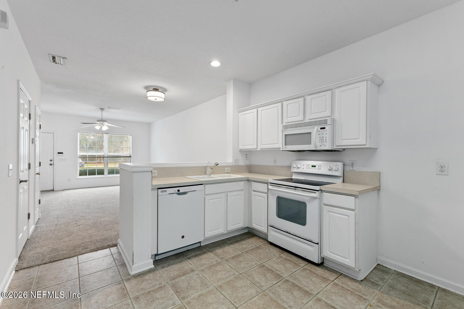 3532 Twisted Tree Lane Jacksonville, FL 32216 - Photo 8 of 23 a kitchen with granite countertop white cabinets and white appliances