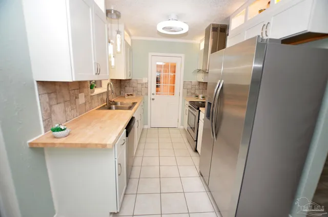 a kitchen with stainless steel appliances granite countertop a refrigerator and a stove