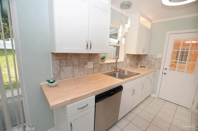 a kitchen with a sink cabinets and window