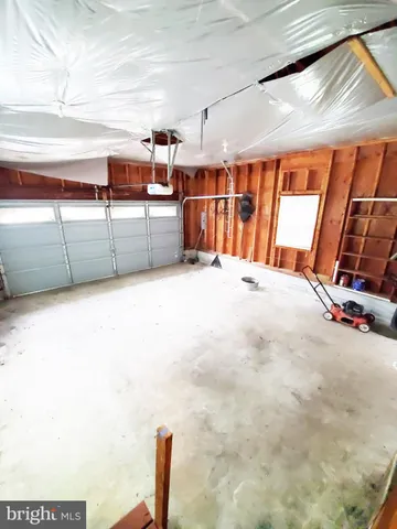 a large white kitchen with cabinets