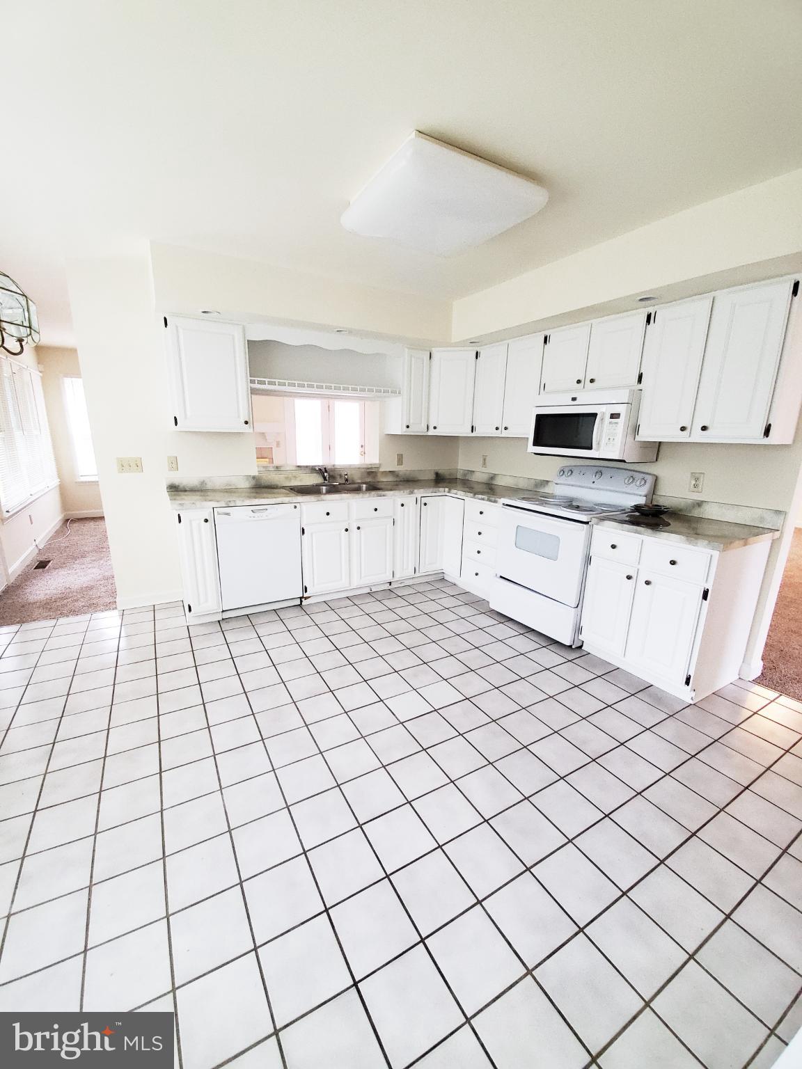 311 A Union Avenue, Unit A Salisbury, MD 21801 - Photo 13 of 38 a large white kitchen with cabinets