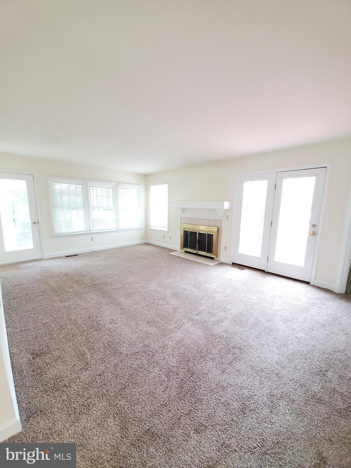 311 A Union Avenue, Unit A Salisbury, MD 21801 - Photo 17 of 38 an empty room with windows and fireplace