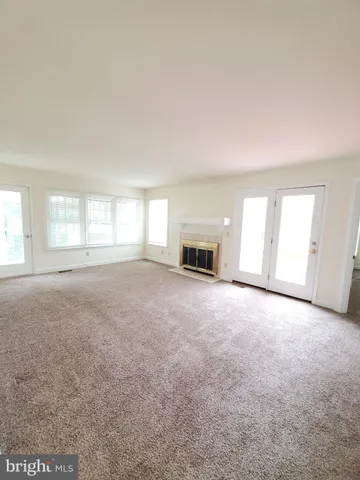 an empty room with large windows