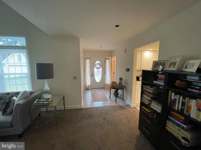 a view of a livingroom with furniture and a window