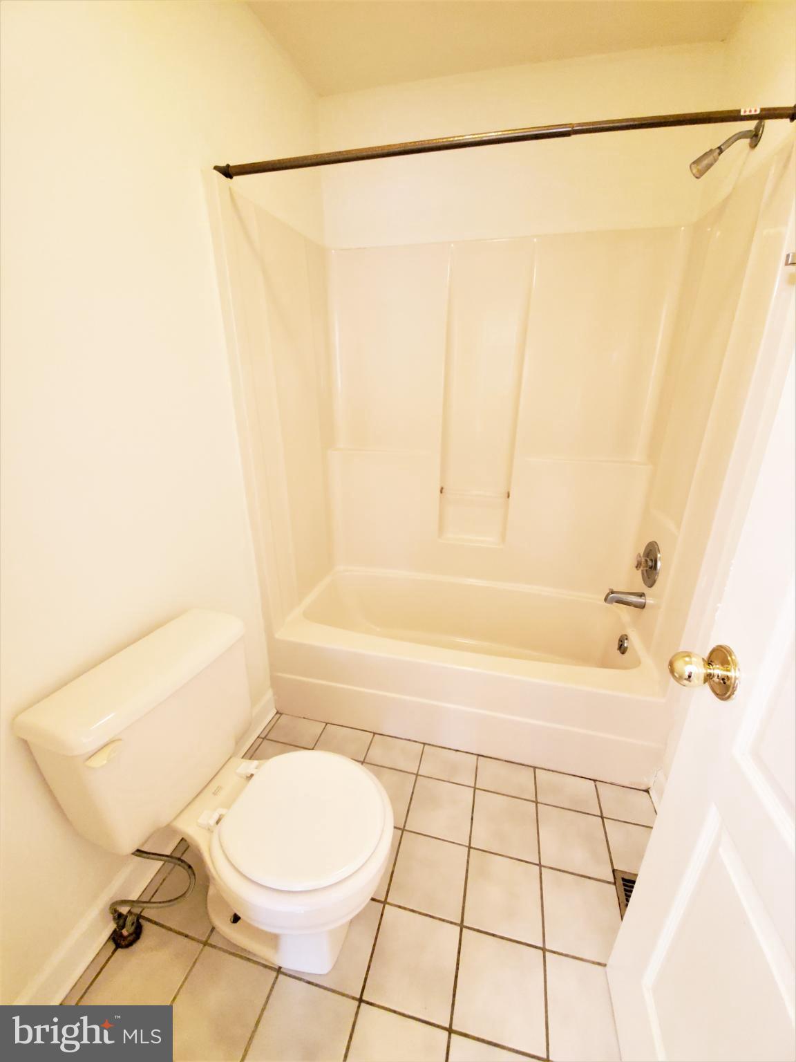 311 A Union Avenue, Unit A Salisbury, MD 21801 - Photo 26 of 38 a bathroom with a toilet and a bathtub