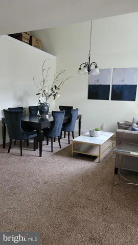 a living room with furniture and a piano