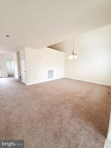 a view of empty room with ceiling fan