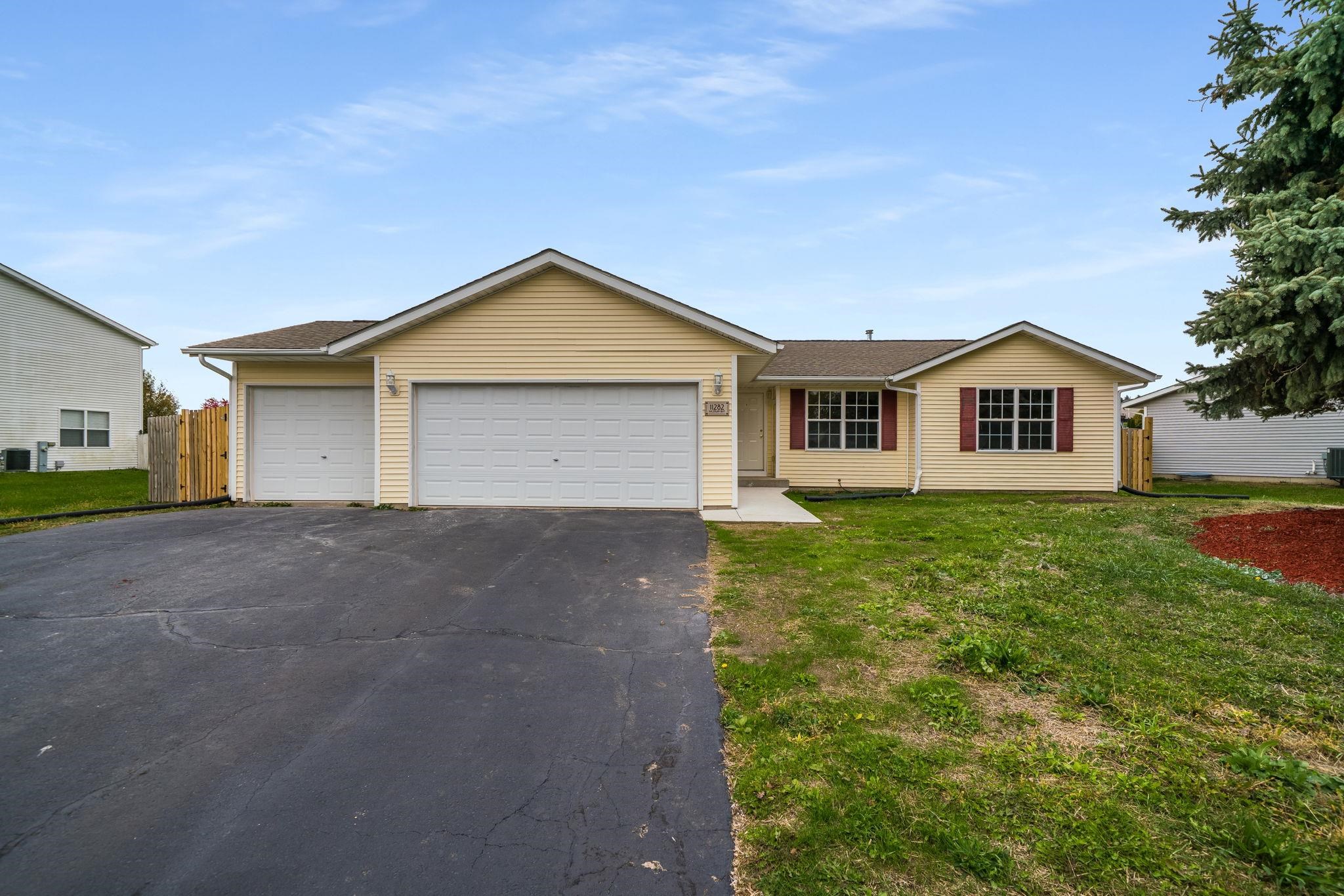 a view of a house with a yard and garage