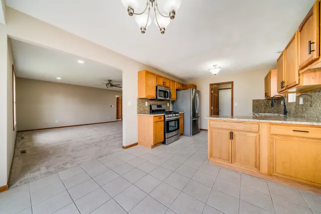 a kitchen with stainless steel appliances granite countertop a sink and cabinets