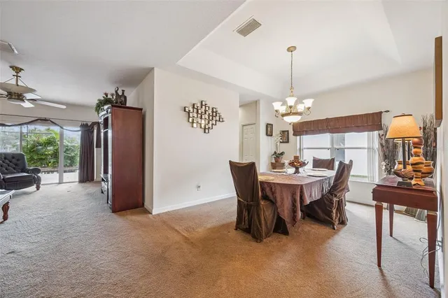 a living room with furniture a flat screen tv and a table