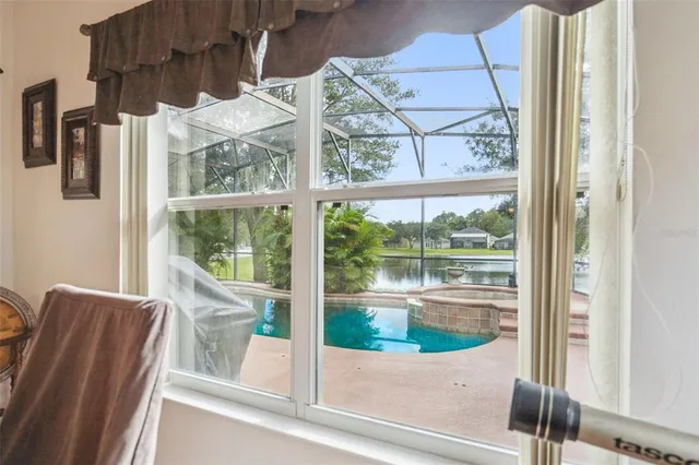 a view of a patio with a table and chairs under an umbrella