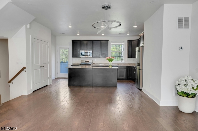 1808 Devon Lane Rockaway, NJ 07866 - Photo 12 of 35 a view of kitchen with stainless steel appliances granite countertop a sink dishwasher a stove a refrigerator and a dining table with wooden floor