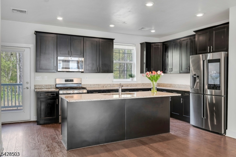 1808 Devon Lane Rockaway, NJ 07866 - Photo 13 of 35 a kitchen with stainless steel appliances granite countertop a refrigerator a sink a stove a microwave and island with wooden floor