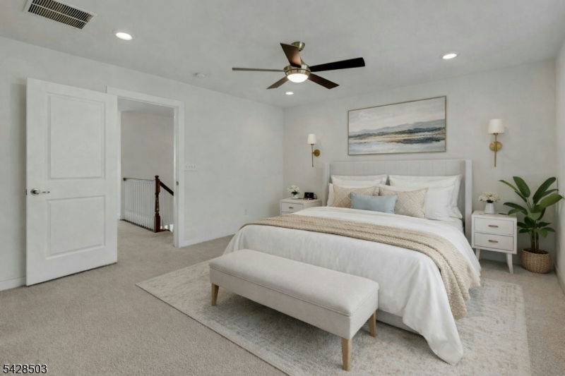1808 Devon Lane Rockaway, NJ 07866 - Photo 16 of 35 a spacious bedroom with a bed and a chandelier