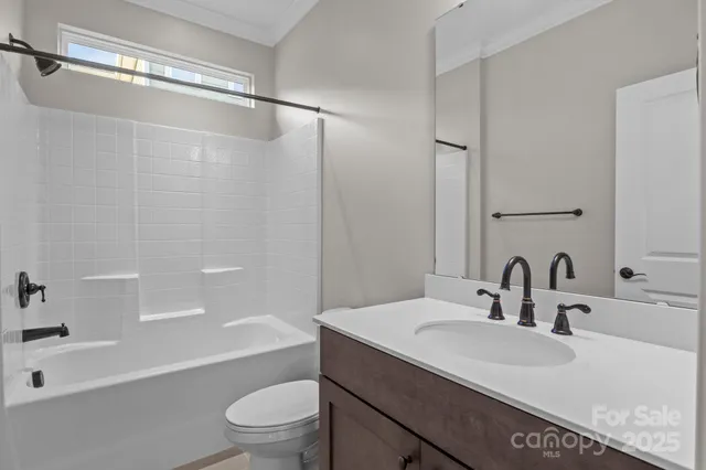 a bathroom with a sink a toilet and a large mirror