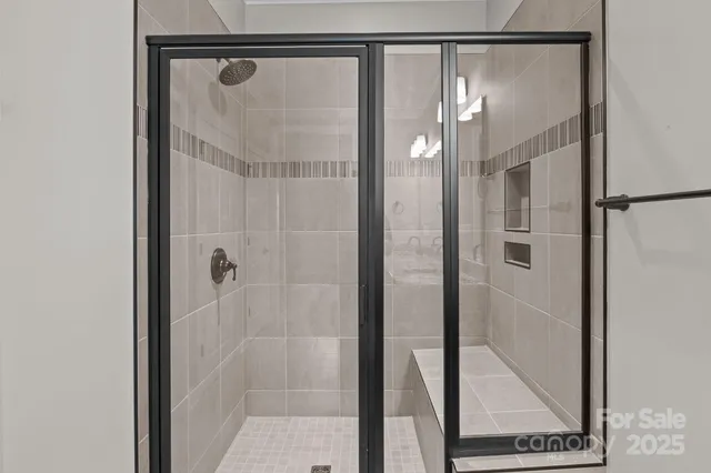 a bathroom with a glass shower door