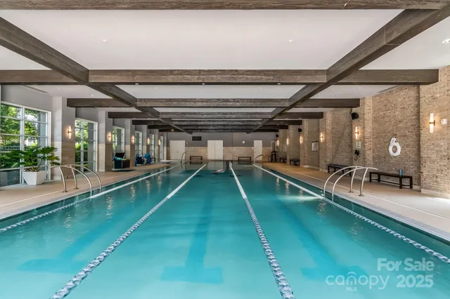 a view of a patio with a dining table and chairs with a small yard