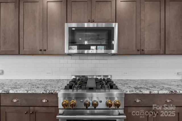 a stove top oven sitting inside of a kitchen