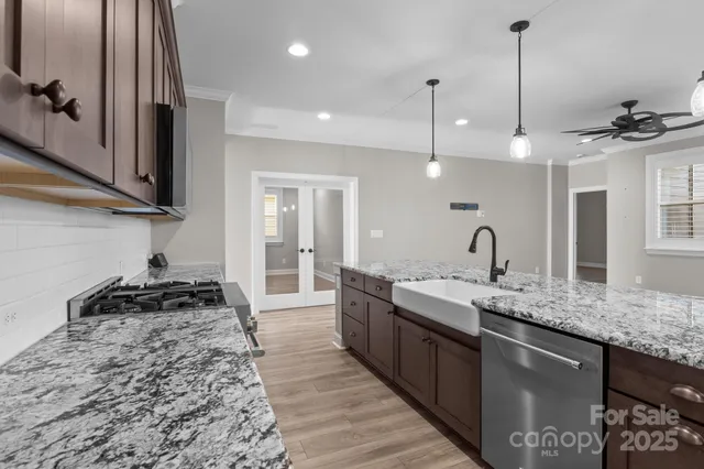 a kitchen with a sink stove and cabinets
