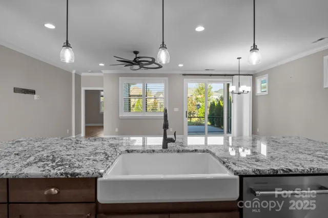 a bathroom with a granite countertop sink and a large mirror
