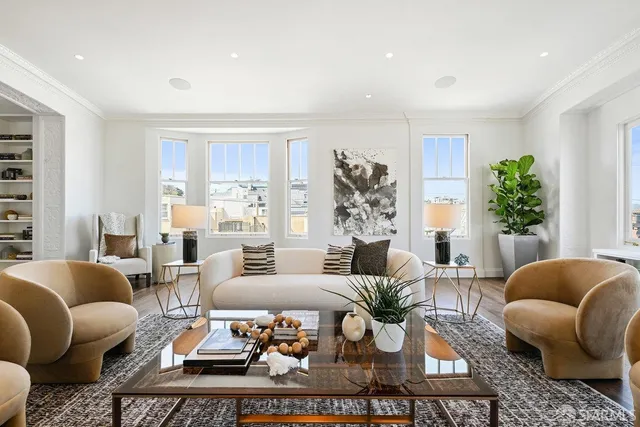 a living room with furniture and a potted plant