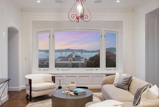 a dining room with furniture potted plants and wooden floor