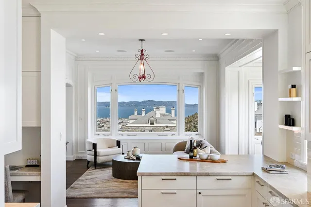 a bedroom with a bed and large window with chair