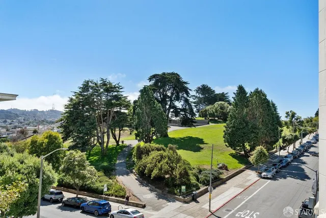 a bathroom with a granite countertop sink toilet a mirror and shower