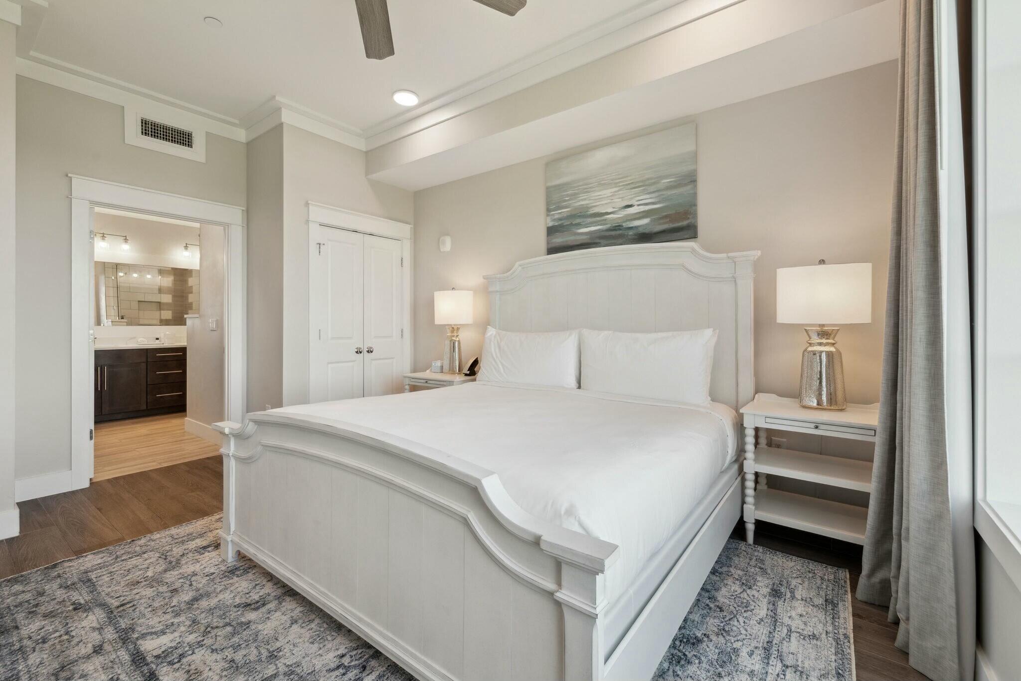202 Henderson Resort Way, Unit 1204 Destin, FL 32541 - Photo 15 of 29 a bedroom with a bed and a lamp