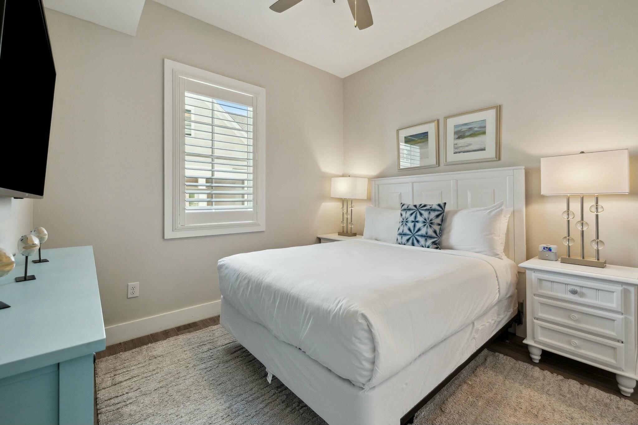 202 Henderson Resort Way, Unit 1204 Destin, FL 32541 - Photo 18 of 29 a bedroom with a bed and a flat screen tv