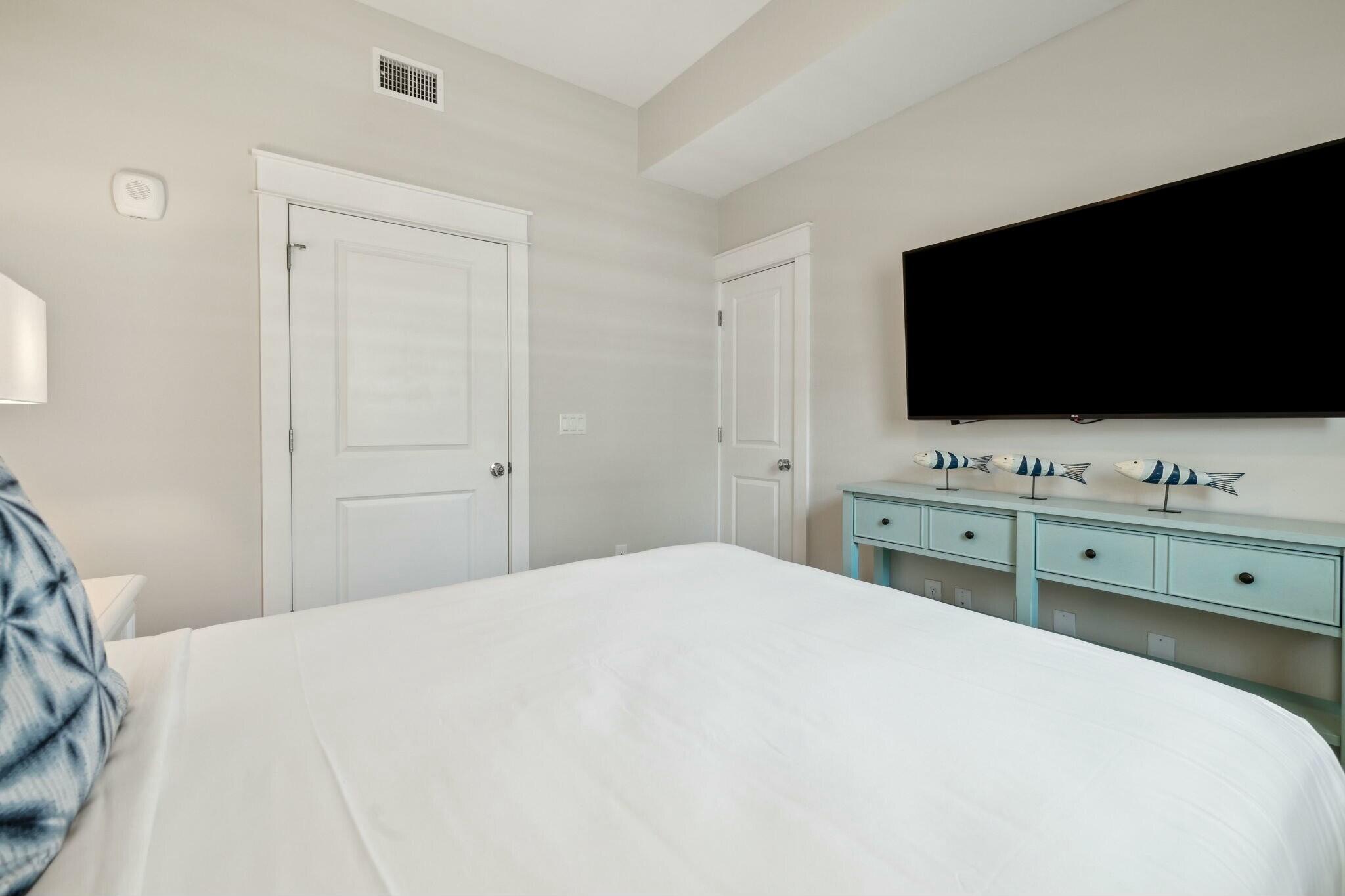 202 Henderson Resort Way, Unit 1204 Destin, FL 32541 - Photo 19 of 29 a bedroom with a bed and a flat screen tv
