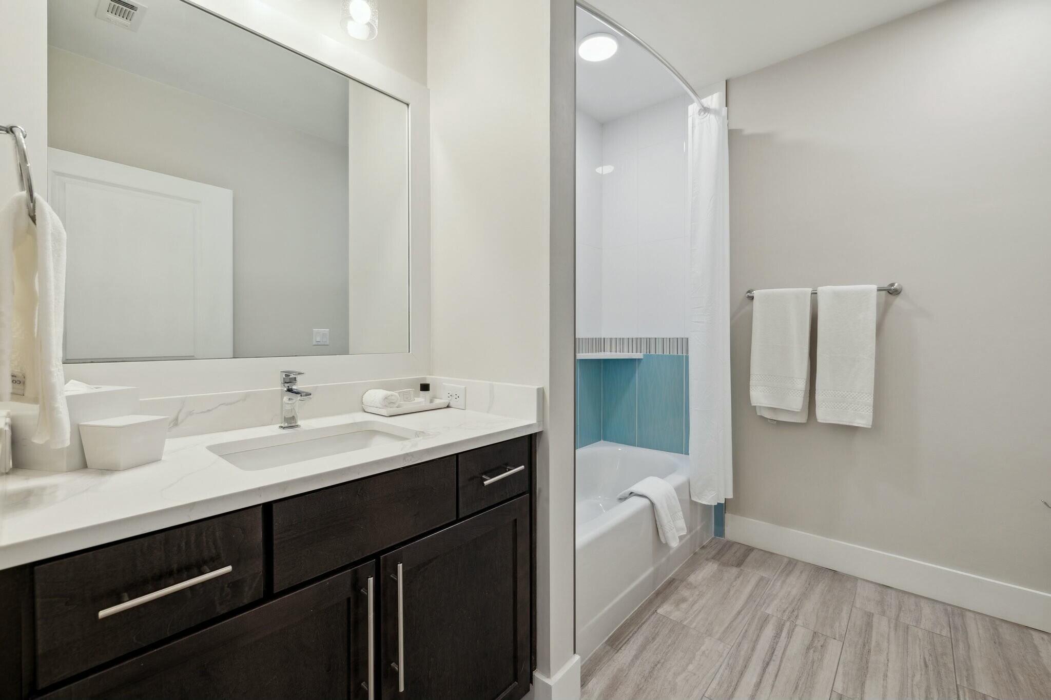 202 Henderson Resort Way, Unit 1204 Destin, FL 32541 - Photo 20 of 29 a bathroom with a toilet sink and mirror