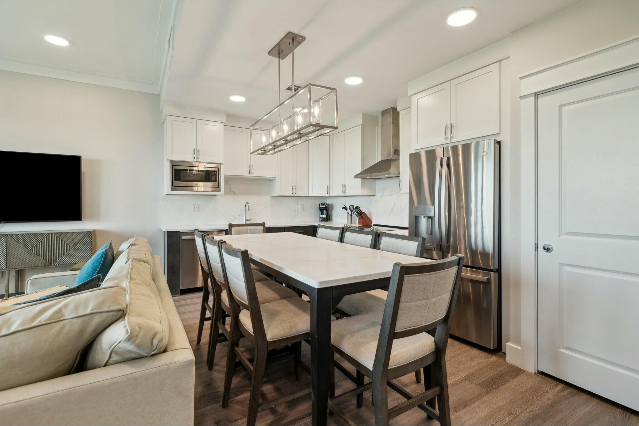 202 Henderson Resort Way, Unit 1204 Destin, FL 32541 - Photo 8 of 29 a kitchen with kitchen island a appliances dining table and chairs