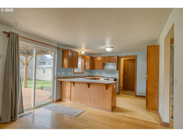 a open kitchen with granite countertop a sink and a refrigerator