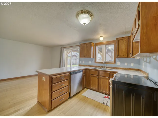 a kitchen with a sink stove and cabinets