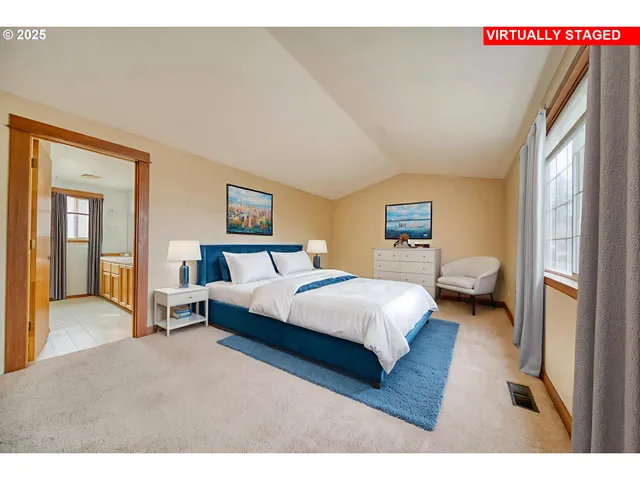 a bedroom with a bed couch and a window