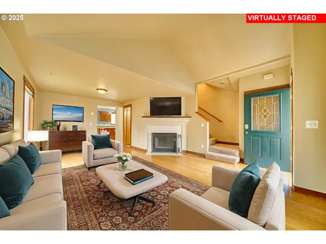 a living room with furniture a fireplace and a flat screen tv