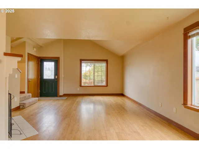 a view of a livingroom with wooden floor and a window