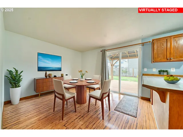 a view of a dining room with furniture and wooden floor
