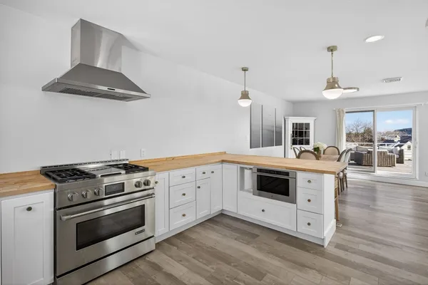 a kitchen with stainless steel appliances a white stove top oven and cabinets
