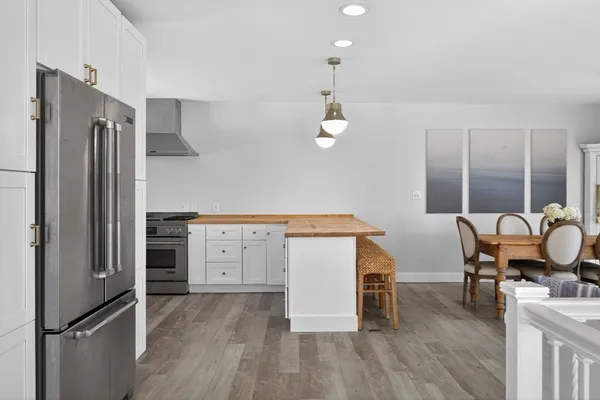 a kitchen with cabinets and wooden floor