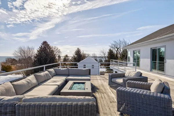 a view of roof deck with couches and city view