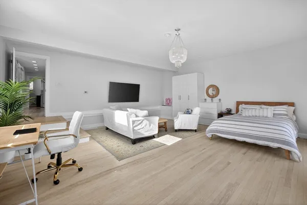 a bedroom with furniture and a flat screen tv