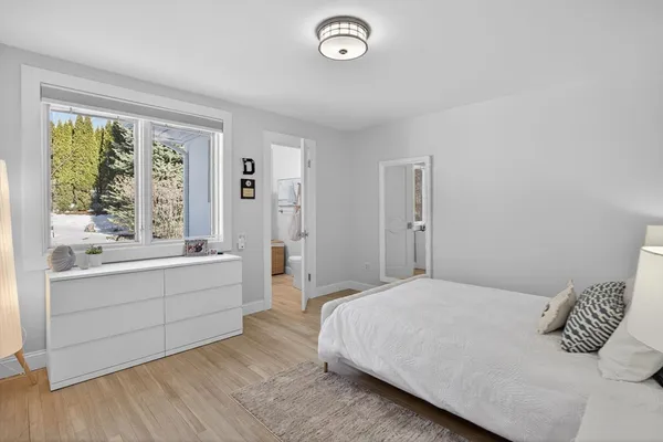 a bedroom with a large bed and a large window