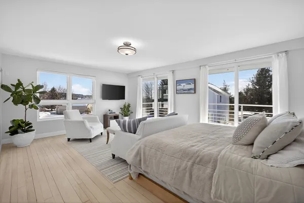 a bedroom with a large bed and a window