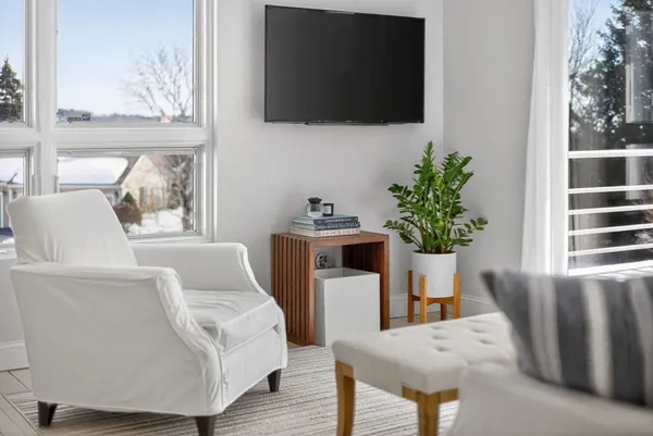 a living room with furniture fireplace and flat screen tv