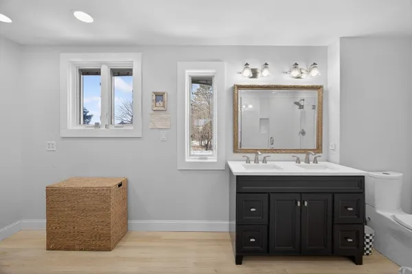 a bathroom with a sink vanity and mirror