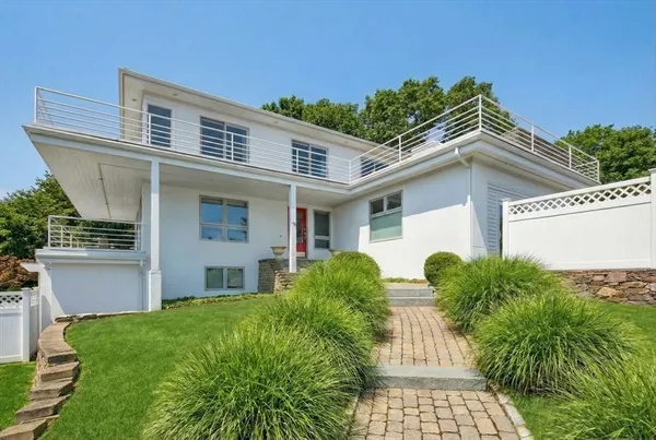 a front view of house with yard and green space