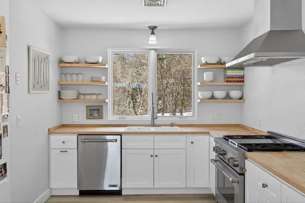 a kitchen with cabinets appliances and a window